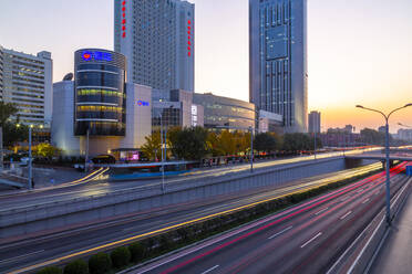 Traffic trail lights on major road near Beijing Zoo at dusk, Beijing, People's Republic of China, Asia - RHPLF13729