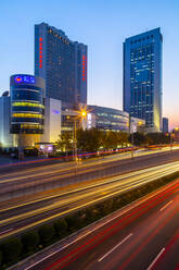 Traffic trail lights on major road near Beijing Zoo at dusk, Beijing, People's Republic of China, Asia - RHPLF13731