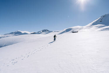 Man in backlight on ski tour, Grisons, Switzerland - HBIF00022