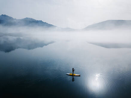 Aerial view of woman stand up paddle surfing, Leon, Spain - DGOF00285