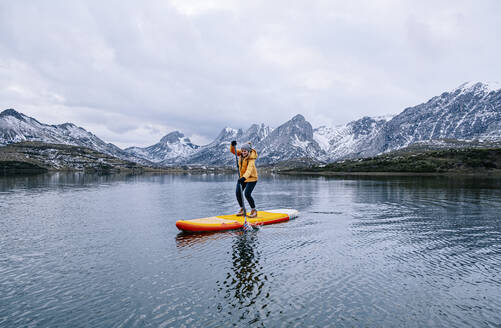 Woman stand up paddle surfing, Leon, Spain - DGOF00330