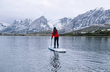 Woman stand up paddle surfing, Leon, Spain - DGOF00333
