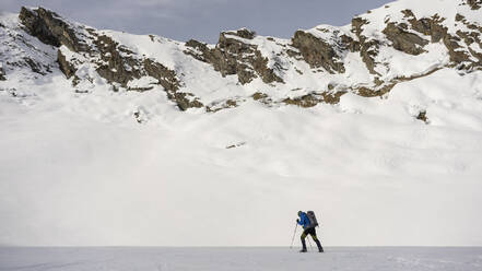 Man on an excursion in snowy mountains, Lombardy, Valtellina, Italy - MCVF00216