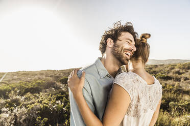 Happy young couple hugging at the coast in summer - SDAHF00140