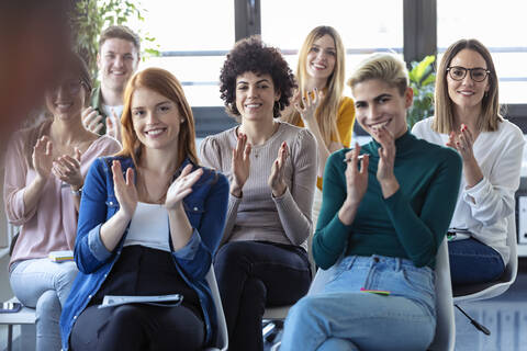 Businesswomen clapping hands during a training stock photo