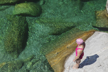 Woman standing at riverside, Verszasca river - GWF06425