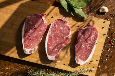 Thick slices of raw meat, rosemary, peppercorn - CUF54720