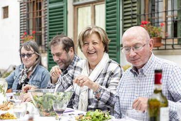Senior couples at outdoor family lunch, Florence, Italy - CUF54743