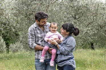 Couple with baby girl in garden, Florence, Italy - CUF54745