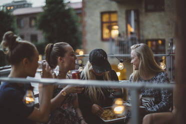 Smiling women talking on balcony - JOHF07899