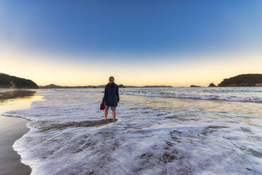 Woman at Hahei Beach during sunrise, Waikato, North Island, New Zealand - SMAF01831
