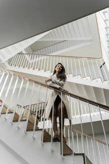 Young woman standing in staircase - AFVF05325