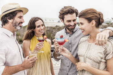 Two couples having cocktails outdoors - SDAHF00157