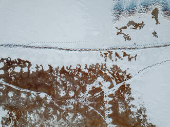Russia, Leningrad Region, Tikhvin, Aerial view of ice at Tikhvinka River in Winter - KNTF04360