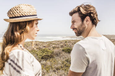 Young couple facing each other at the coast - SDAHF00173