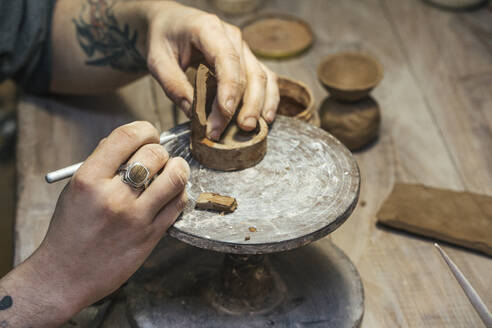 Close-up of potter working on workpiece - VPIF02010