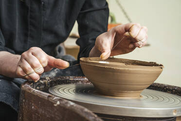 Close-up of potter working on workpiece - VPIF02019