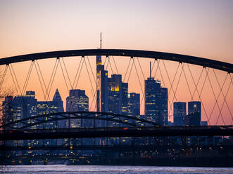 Germany, Hesse, Frankfurt, Frankfurt am Main skyline behind the Ostend Bridge at dusk - AMF07827