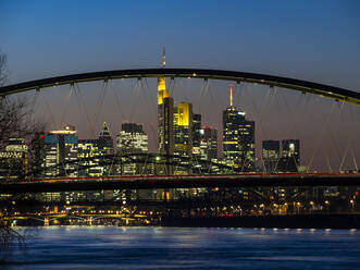 Germany, Hesse, Frankfurt, Frankfurt am Main skyline behind the Ostend Bridge at dusk - AMF07829