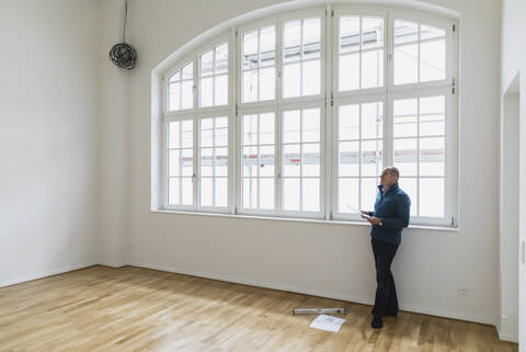 Man checking specifications of refurbished kuxury loft stock photo