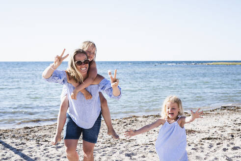 Mother with daughters on beach - JOHF08068