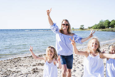 Mother with daughters on beach - JOHF08069