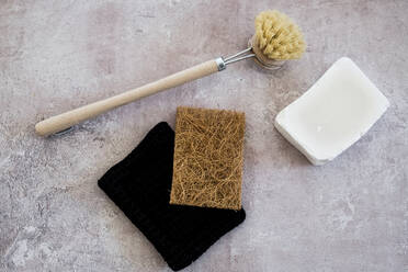 High angle close up of wooden washing up brush, soap and sponges. - MINF13645