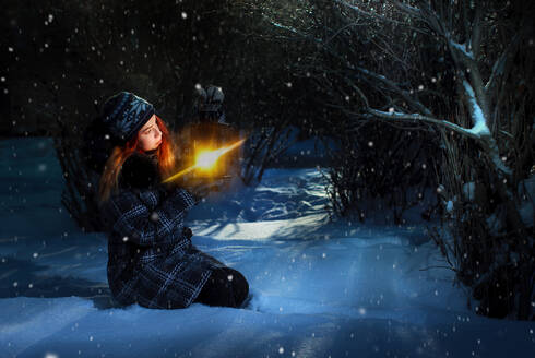 Pretty redhead girl holding lantern in winter forest - CAVF74683