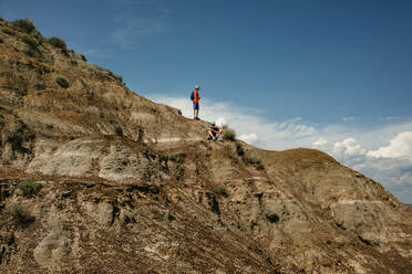 Theo teen boys standing on rock at Horsethief Canyon in Drumheller, Alberta - CAVF74698