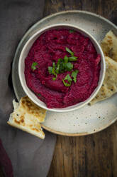 Bowl of vegan beetroot hummus with pita bread - LVF08620