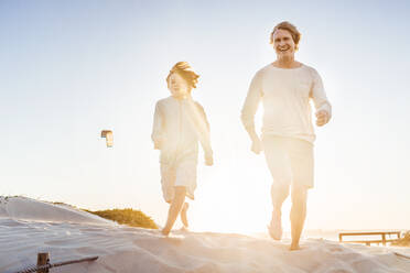 Vater hat Spaß mit seinem Sohn am Strand, läuft im Sand - SDAHF00409