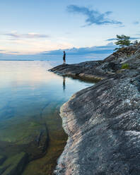 Man standing on coast - JOHF08305