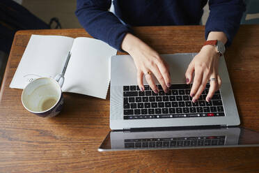 Young woman using laptop at home - JOHF08351