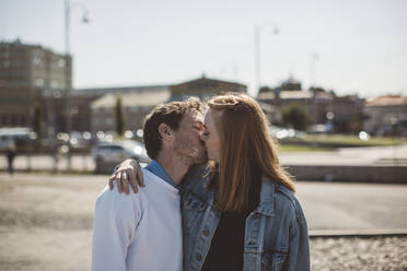 Couple kissing outdoors - JOHF08435