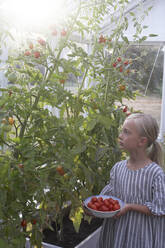 Mädchen hält Schüssel mit frischen Tomaten - JOHF08515