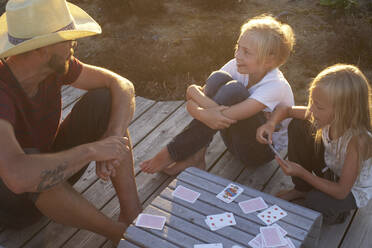 Father and children playing cards - JOHF08516