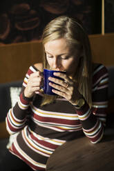Woman drinking from mug - JOHF08557