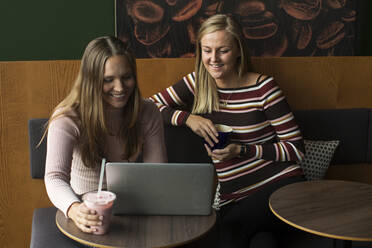 Two women using laptop - JOHF08570