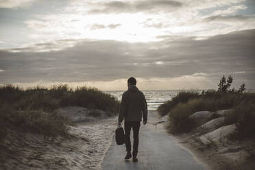 Man walking on beach - JOHF08622