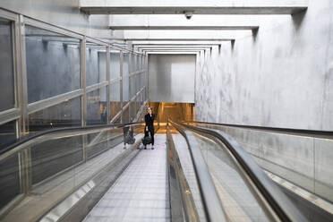 Woman on moving walkway - JOHF08652