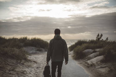 Man walking on beach - JOHF08680