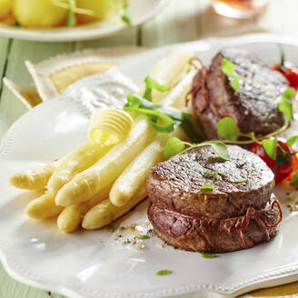 White asparagus and beef fillet on plate in restaurant - DREF00046