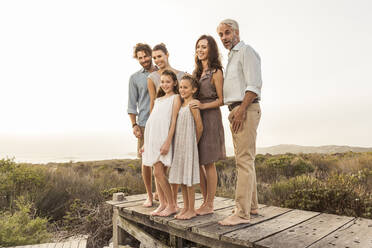 Large family enjoying the sunset standing on a boardwalk - SDAHF00481