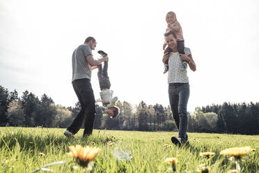 Happy family with two kids having fun on a meadow in spring - WFF00281