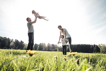 Happy family with two kids on a meadow in spring - WFF00284
