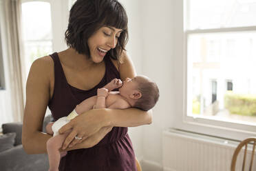 Happy mother holding newborn baby son - HOXF04922