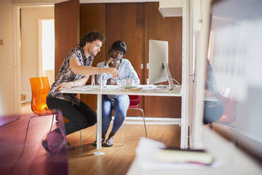 Young multiethnic couple working in home office - HOXF05018