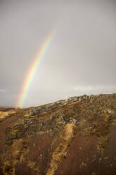 Rainbow above rocky landscape - JOHF08755