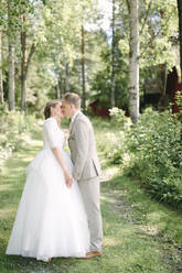 Bride and groom kissing - JOHF08779