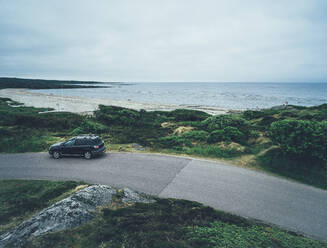 Car on coastal road - JOHF08883